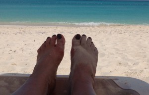 CROPPED FEET IN SAND